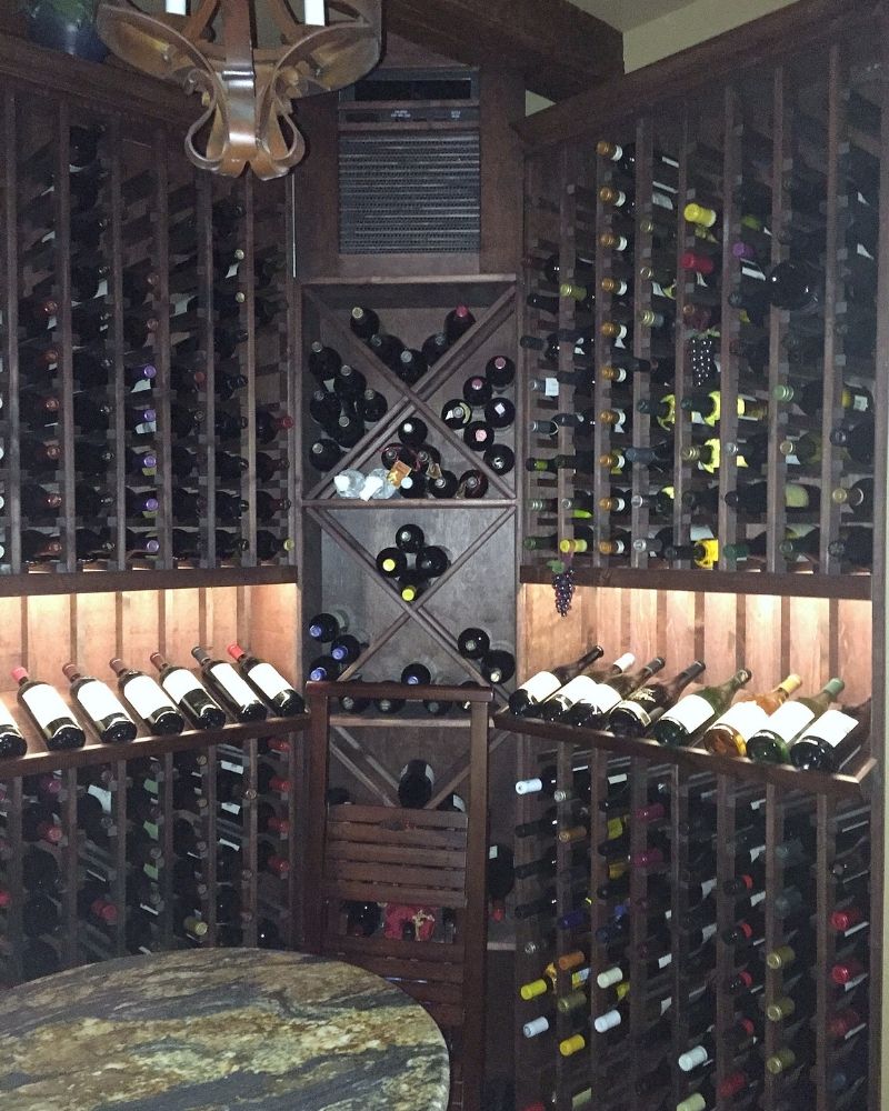Elegant wine cellar with wooden racks displaying a variety of wine bottles, perfect for connoisseurs and collectors.