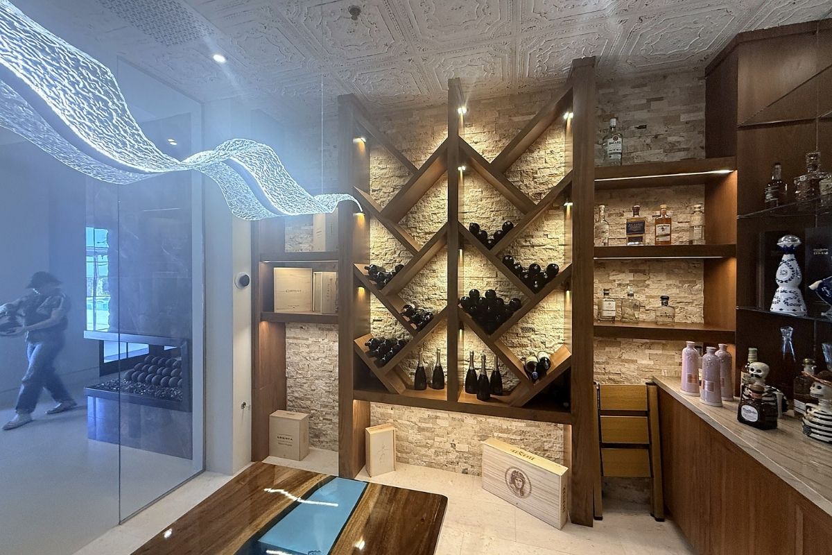 Elegant wine cellar showcasing a stylish wooden rack, illuminated bottles, and unique decor in a modern setting.
