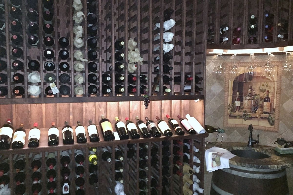 Elegant wine cellar displaying various bottles, glasses, and a rustic decor for wine enthusiasts. Perfect for storage and tasting.