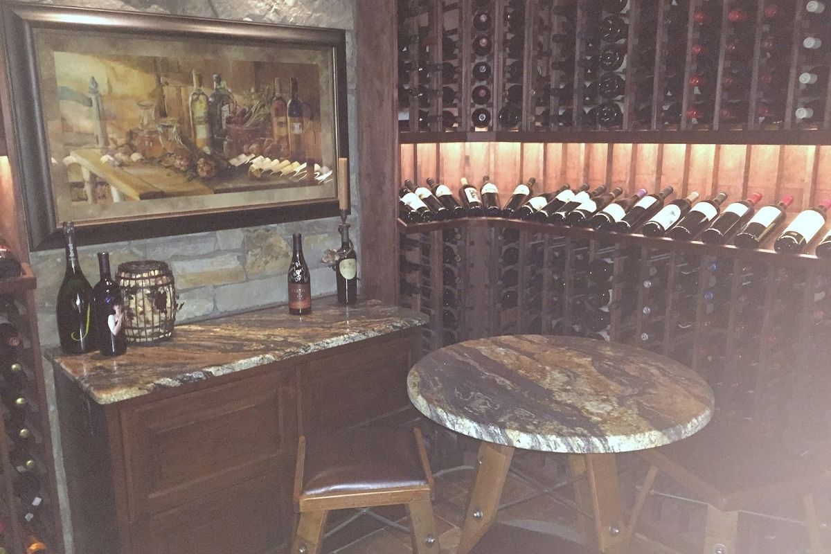 Cozy wine cellar featuring elegant bottles, a rustic table, and an art piece highlighting wine culture. Perfect for connoisseurs.